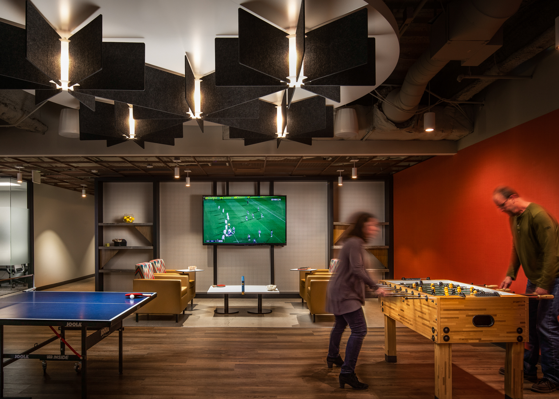 Office Breakroom with people playing Foosball, image taken by Architectural Photographers in Western North Carolina